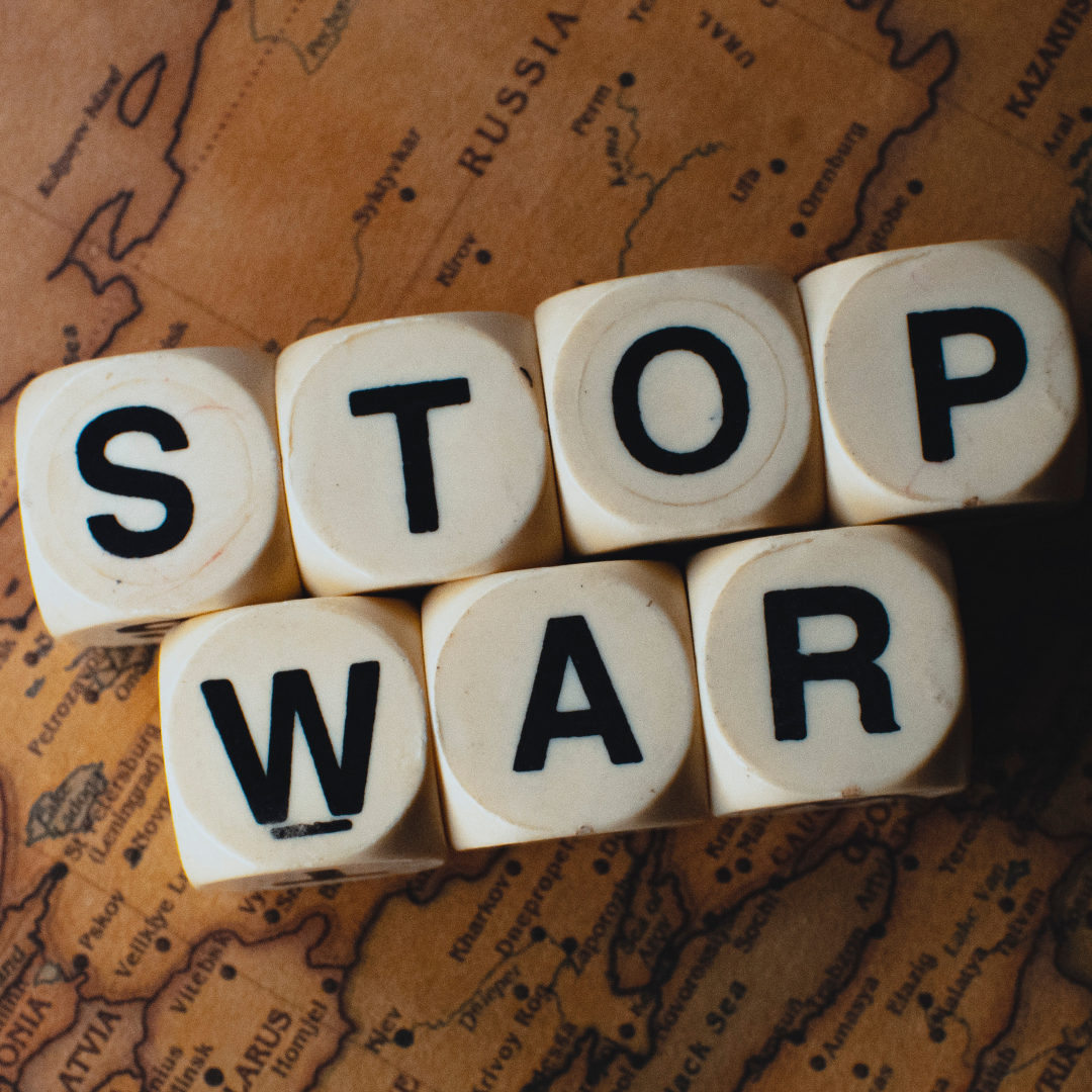 Game pieces that spell "stop war" on a background of a map. Game pieces that spell "stop war" on a background of a map.