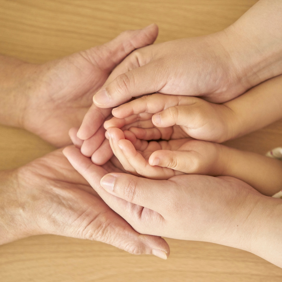 Three generations of hands, cupped and holding the next generation. Three generations of hands, cupped and holding the next generation.