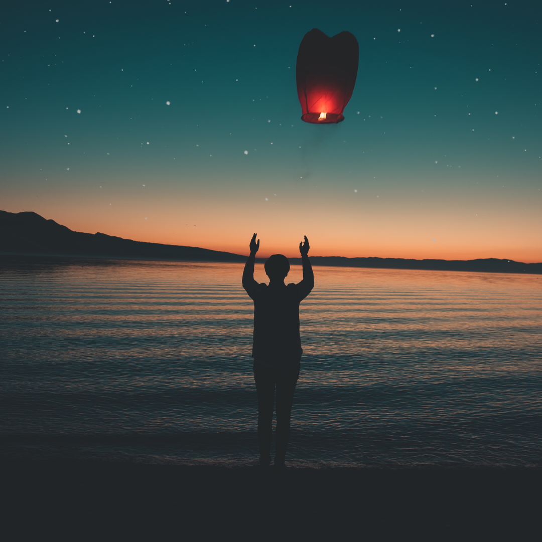 A sunset lantern release. A sunset lantern release.