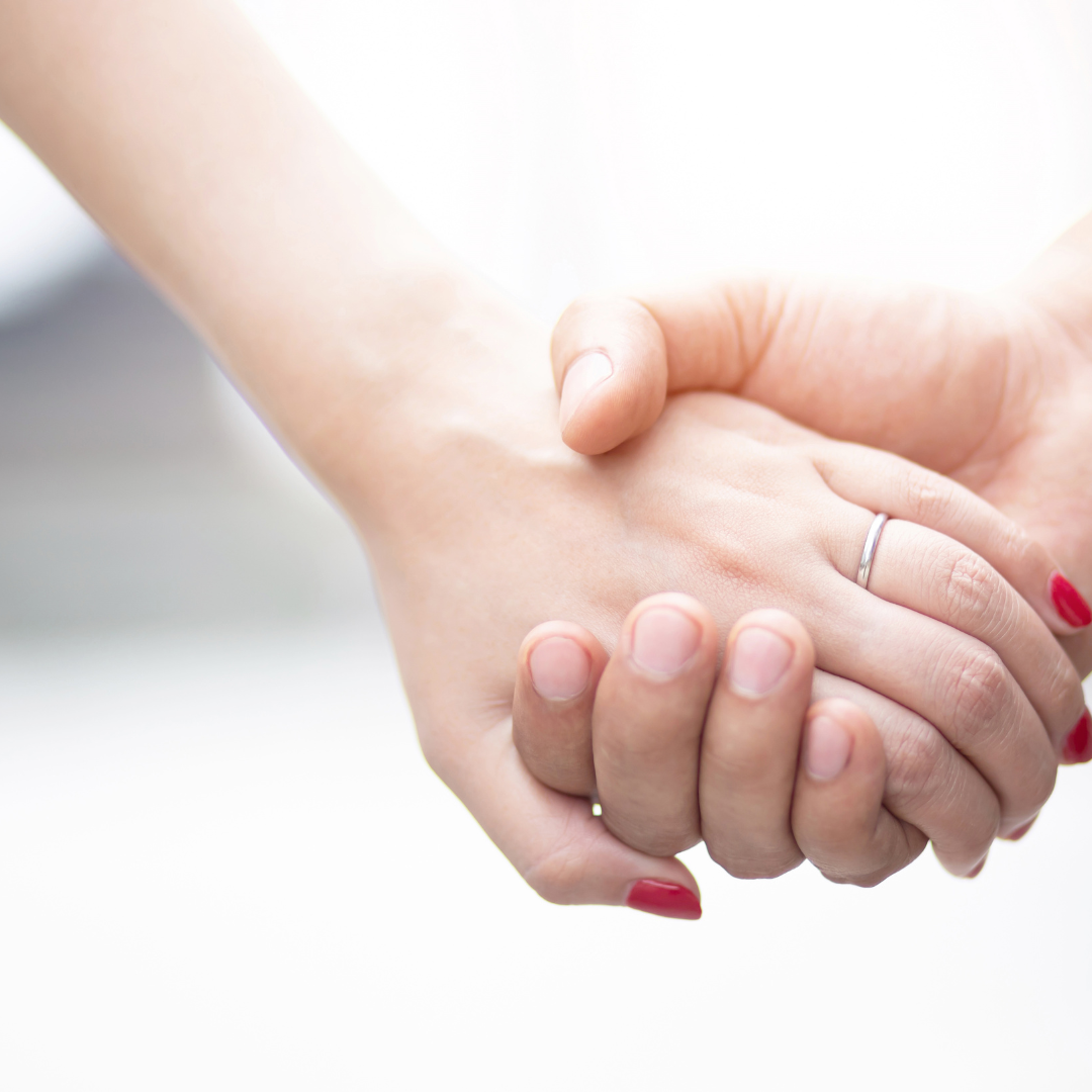 Two hands holding tightly.