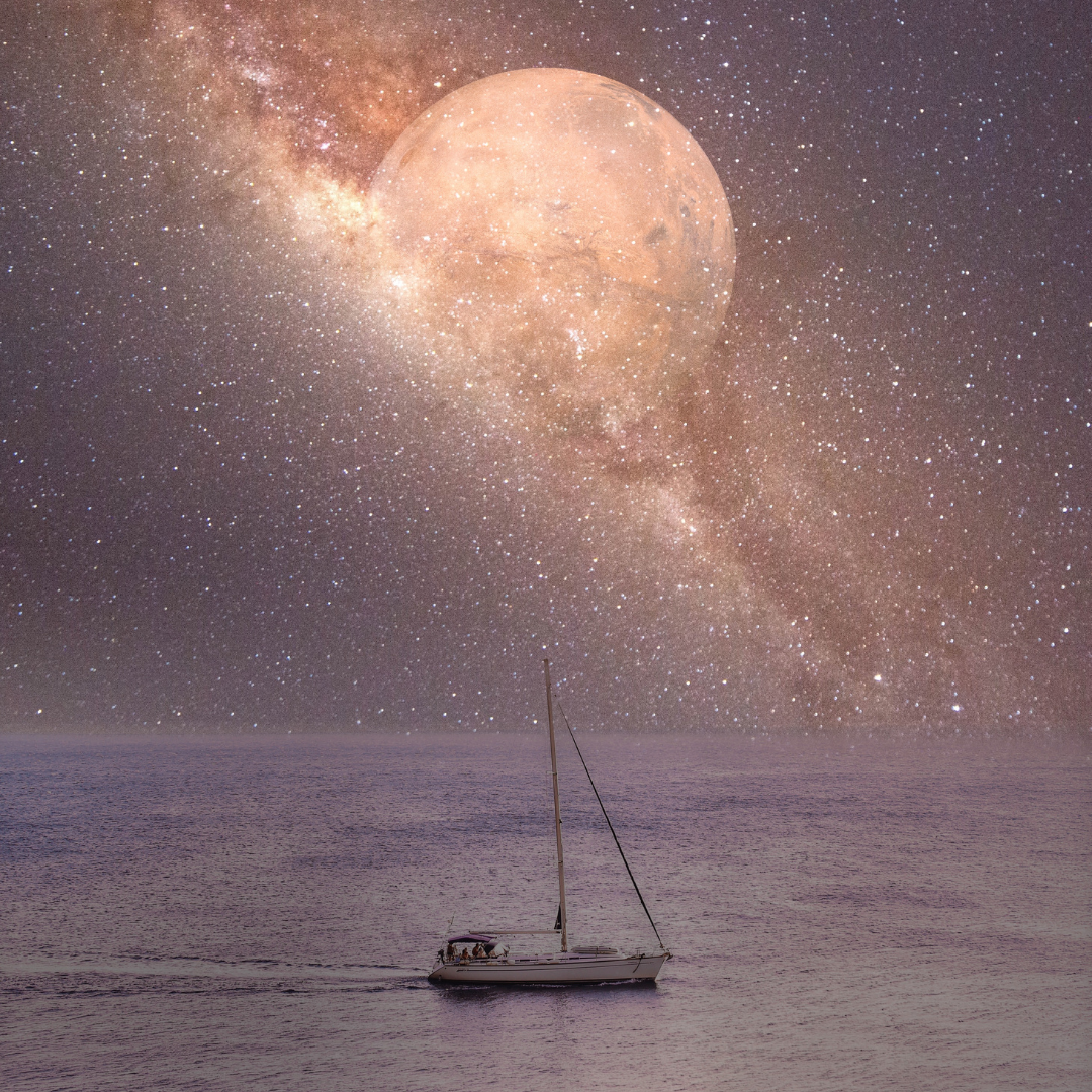 An image of a sailboat with its' sails down, on calm waters with the Milky Way Galaxy and the full moon glowing in the night sky.