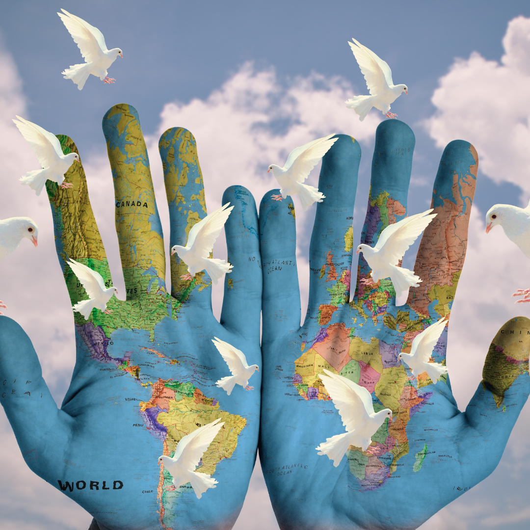 The image is of two hands palms up and side by side. The hands are covered in an image of a world map with blue oceans and multicolored countries. The foreground has white doves flying above and around the hands. The background is blue sky and puffy white clouds. The image is of two hands palms up and side by side. The hands are covered in an image of a world map with blue oceans and multicolored countries. The foreground has white doves flying above and around the hands. The background is blue sky and puffy white clouds.